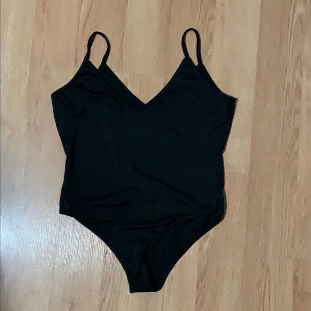 Black body suit. Lycra type material. Size small.